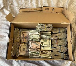 a shoebox full of money.png